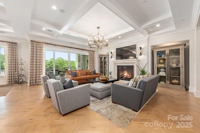 Incredible herringbone flooring in Living Room with coffered ceiling and built-ins with gas fireplace