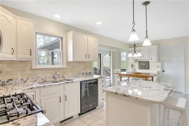 Cross view showing the built in desk, access to the covered rear deck and access to the laundry/ garage.
