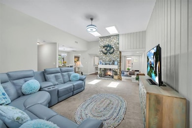 Family Room with vaulted ceilings with skylights & open floor plan