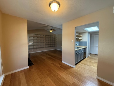 Kitchen with lofted ceiling, sink, a textured ceil