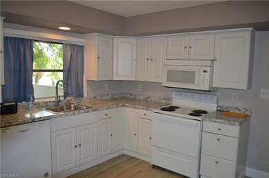 Kitchen featuring light stone countertops, light h