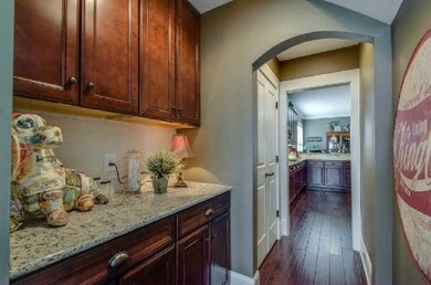 Butlers pantry to leading to kitchen with granite 