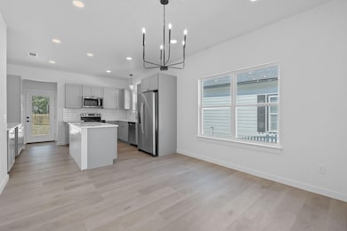 Kitchen featuring stainless steel appliances, gra