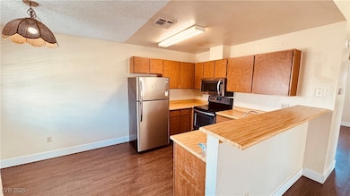 Kitchen featuring stainless steel appliances, dark