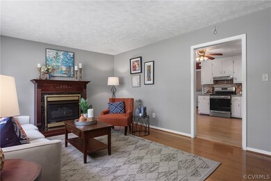 Living room with a textured ceiling, hardwood / wo