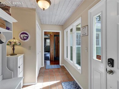 Corridor with light tile floors and wooden ceiling