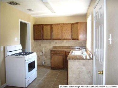 New stove, cabinets, tile backsplash, ceramic tile