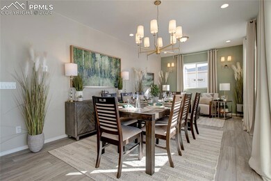Dining area with a notable chandelier and light ha