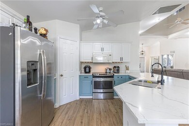 Kitchen featuring white cabinetry, sink, ceiling f