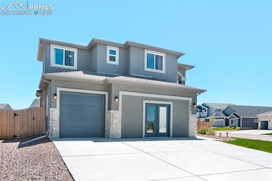 Prairie-style house with an attached garage, stucco siding, stone siding, and concrete driveway