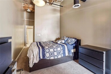 Bedroom with a high ceiling, visible vents, and ca