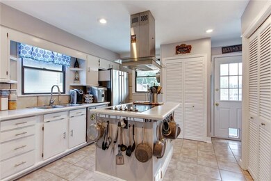 Sunny kitchen with stainless appliances and new ti