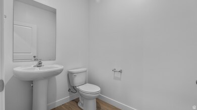 Bathroom with baseboards and wood finished floors