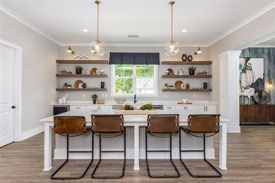 Kitchen featuring white cabinetry, a kitchen bar, 