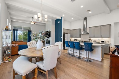 Dining area with beam ceiling, light wood-style f