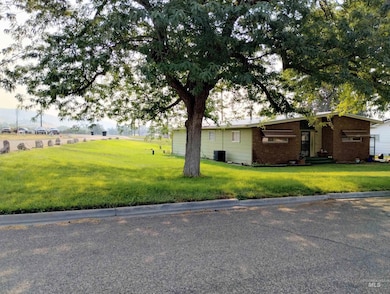 View of home's exterior with a lawn and brick siding