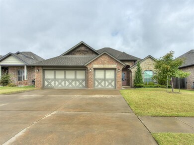 View of front of house with a garage and a front y