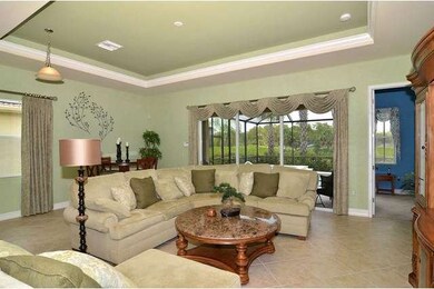 Large great room with tile, tray ceiling and golf views!