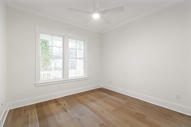 Also located off the foyer is a convenient guest bedroom, with high ceilings, 2 large windows, and a a ceiling fan.