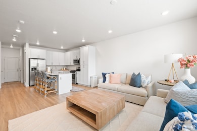 Living room featuring light wood-type flooring and recessed lighting