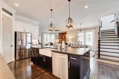 Kitchen with stainless steel appliances, a sink, a chandelier, healthy amount of natural light, and recessed lighting