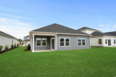 Rear view of property featuring a lawn, a patio, a