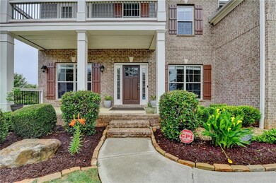Property entrance with brick siding and a balcony