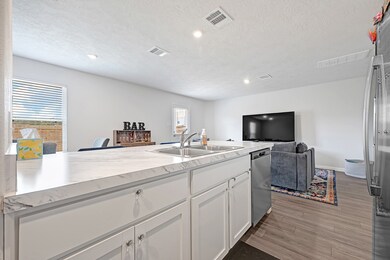 Bright, open-concept kitchen and living area with