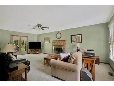 Large family room with brick fireplace, ceiling fa