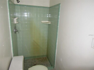 Bathroom One - dual access from Bedroom and from Kitchen. Shower only and needs some repairs.