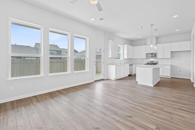 Kitchen with ceiling fan, visible vents, light co