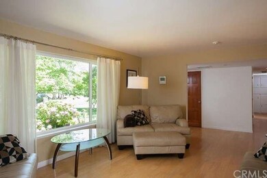 Huge living room window and gleaming red oak floor