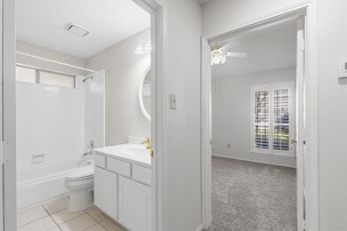 Bathroom featuring ceiling fan, bathing tub / show