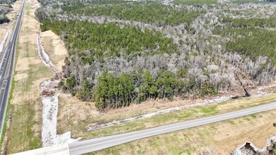 View of property location featuring a forest