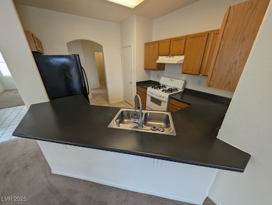 Kitchen featuring freestanding refrigerator, white