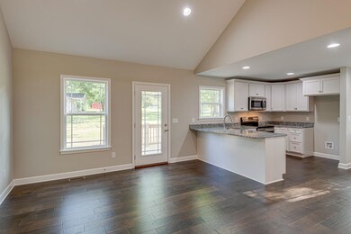 This is the same plan being built. Photo is taken from another build. Buy now and help select your finishes. Shaker style farmhouse cabinetry and granite or quartz countertops.