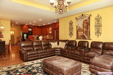 Spacious den/family room with tray ceiling and a g