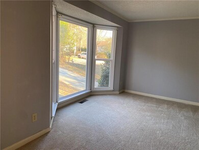 Unfurnished room featuring ornamental molding, lig