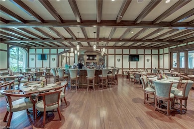 Dining room with beam ceiling, wood-type flooring, and coffered ceiling