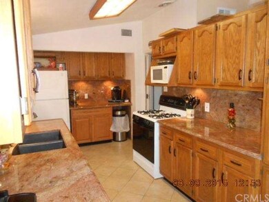 The kitchen has under-cabinet lighting, a vaulted 