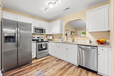 Kitchen featuring stainless steel appliances, whit