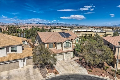 View of front of home with driveway, a garage, a m