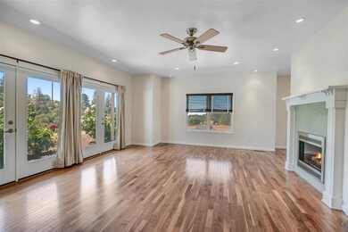 Gorgeous Living Room featuring fireplace, ceiling fan, and french doors