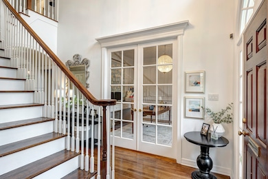 Handsome study off the entry has doors for privacy