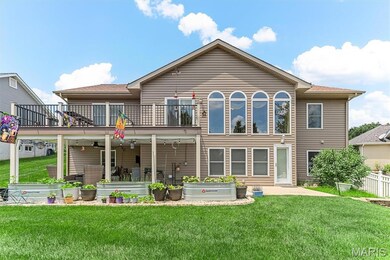 View of yard featuring a patio, outdoor lounge area, a balcony, and ceiling fan