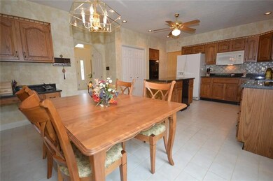 Notice the double wall ovens, gas cook top, island