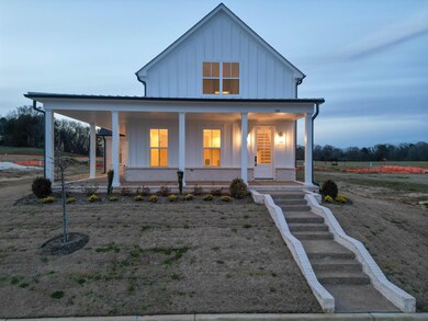 View of front facade with a porch, brick siding, a