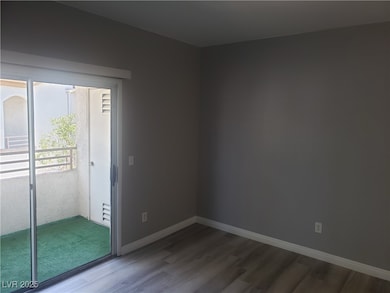 Unfurnished room with wood finished floors and bas