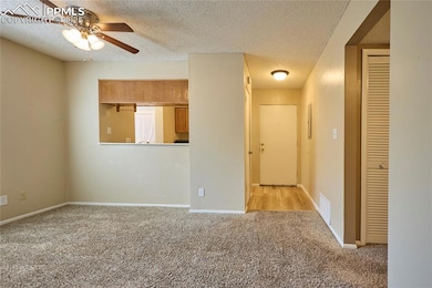 Dining area with carpet floors, pass through from 