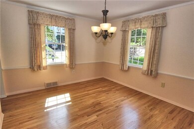 Dining room has a corner cabinet, refinished hardw